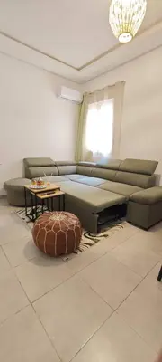 a living room with a couch and a table at Appartement a 5 min de l aeroport de marrakech in Marrakech