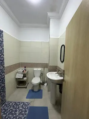 a bathroom with a toilet and a sink at Appartement a 5 min de l aeroport de marrakech in Marrakech