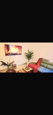 a living room with a couch and a fireplace at Appartement a 5 min de l aeroport de marrakech in Marrakech