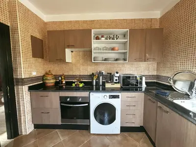 a kitchen with a washing machine and a sink at Villa Dar Ouladi - Marrakech - Pool & Rooftop in Marrakech