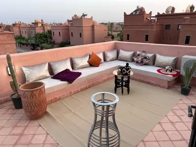a couch sitting on top of a balcony at Villa Dar Ouladi - Marrakech - Pool & Rooftop in Marrakech