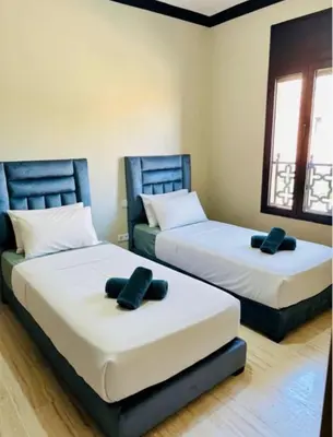two beds in a room with at Villa Dar Ouladi - Marrakech - Pool & Rooftop in Marrakech