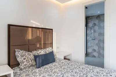 a bedroom with a bed with a headboard and pillows at Villa Nayma in Marrakech