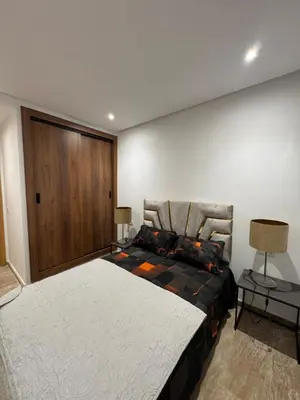 a bedroom with a large bed and two lamps at Opera 3 in Marrakech