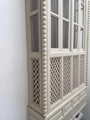 a white cabinet with two windows on a wall at Riad 4 chambres, Piscine, Pdj inclus in Marrakech