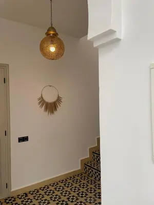 a room with a mirror on the wall and a staircase at Riad 4 chambres, Piscine, Pdj inclus in Marrakech