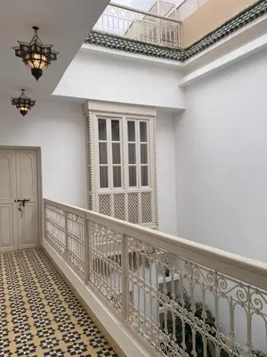 a balcony with a wrought iron railing and a door at Riad 4 chambres, Piscine, Pdj inclus in Marrakech