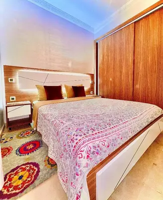 a bedroom with a large bed in a room at Lilia apartment marrakech in Marrakech