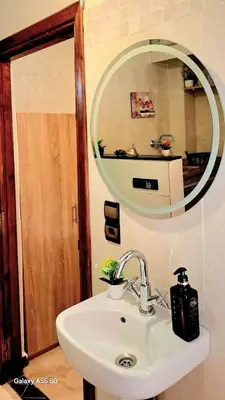 a bathroom with a sink and a mirror at Red Studio Marrakech in Marrakech
