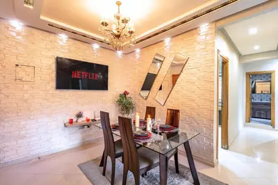 a dining room with a brick wall at Emeraude - Confort et parking privé in Marrakech