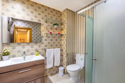 a bathroom with a toilet and a sink and a shower at Emeraude - Confort et parking privé in Marrakech