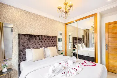 a bedroom with two beds and a large mirror at Emeraude - Confort et parking privé in Marrakech