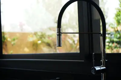 a close up of a kitchen sink with a window at Villa Lily in Tameslouht