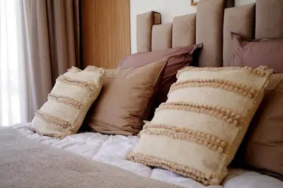 a bed with pillows on top of it with at Villa Lily in Tameslouht