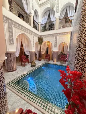 a swimming pool in the middle of a building at Riad Mon Pote in Marrakech