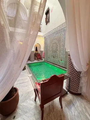 a swimming pool in the middle of a room at Riad Mon Pote in Marrakech
