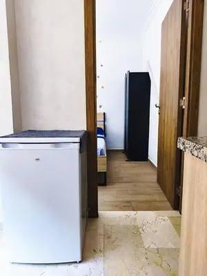 a hallway with a refrigerator in a room at Cocoon Apartment & Pool ctm aeropot train station in Marrakech