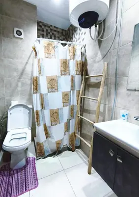 a bathroom with a toilet and a shower curtain at Cocoon Apartment & Pool ctm aeropot train station in Marrakech