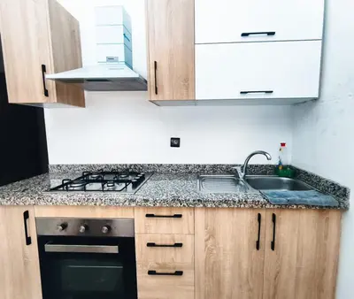 a kitchen with a sink and a stove at Cocoon Apartment & Pool ctm aeropot train station in Marrakech
