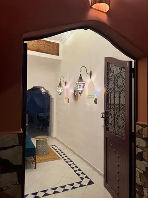 an open door with lights on the wall at Riad LK25 in Marrakech