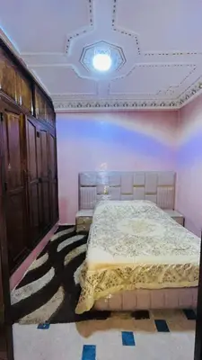a bedroom with a large bed in a room at Appartement in Marrakech
