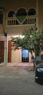 a building with a tree in front of a building at Appartement in Marrakech