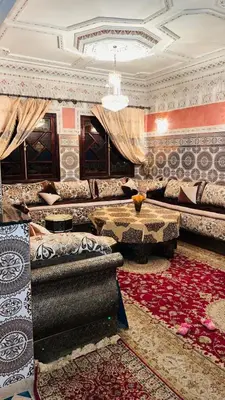 a living room with couches and a chandelier at Appartement in Marrakech