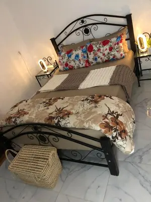 a bedroom with a bed with a wrought iron headboard at Stylish Moroccan Apartment in Marrakech