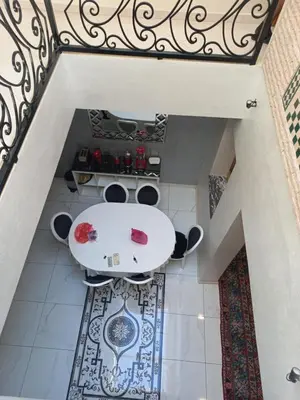 a dining room with a table and a staircase at Breeze home in Marrakech