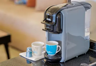 a coffee machine with two cups on a counter at Charmant appartement avec terrasse au cœur de Marrakech in Marrakech