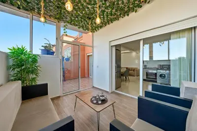 a living room with blue chairs and a table at Charmant appartement avec terrasse au cœur de Marrakech in Marrakech