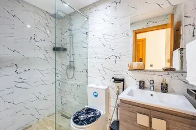 a bathroom with a shower and a toilet and a sink at Atlas Light Heart of Gueliz & Parking in Marrakech