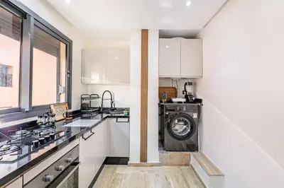 a kitchen with a washer and dryer in it at Atlas Light Heart of Gueliz & Parking in Marrakech
