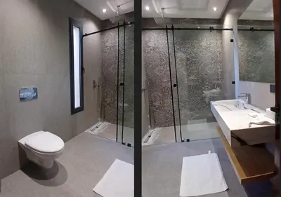 a bathroom with a shower and a toilet and a sink at Villa Soleil Couchant in Marrakech
