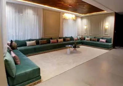 a living room with a green couch and a table at Villa Soleil Couchant in Marrakech