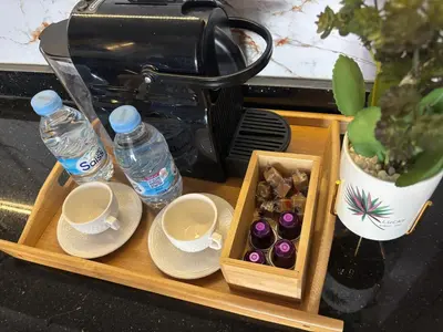 a tray with cups and plates and water bottles at Appartement Original et unique en plein hivernage pour familles in Marrakech