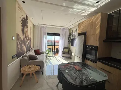 a living room with a couch and a table at Appartement Original et unique en plein hivernage pour familles in Marrakech