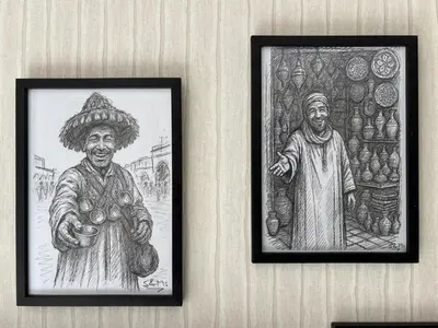 two drawings of two people hanging on a wall at Appartement Original et unique en plein hivernage pour familles in Marrakech