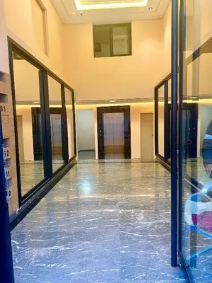 an empty hallway of a building with glass doors at Appartement Original et unique en plein hivernage pour familles in Marrakech