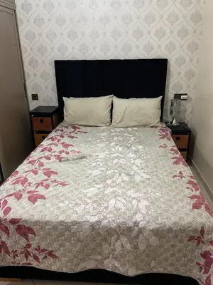 a bedroom with a large bed with a comforter at My Marrakesh - G Floor in Marrakech