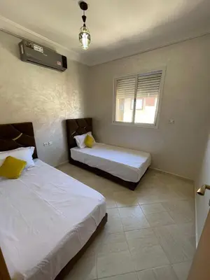 a bedroom with two beds and a window at View Marrakech Apartment in Marrakech