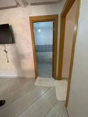 a bathroom with a glass door leading to a shower at View Marrakech Apartment in Marrakech