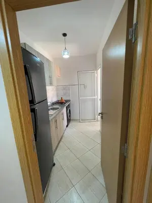 a kitchen with a refrigerator and a tile floor at View Marrakech Apartment in Marrakech