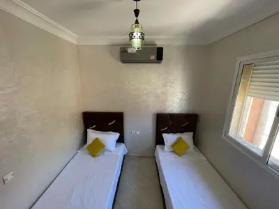 a room with two beds and a window at View Marrakech Apartment in Marrakech