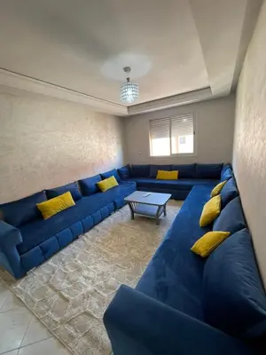 a living room with a blue couch and yellow pillows at View Marrakech Apartment in Marrakech