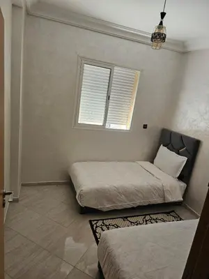 a bedroom with two beds and a window at View Marrakech Apartment in Marrakech