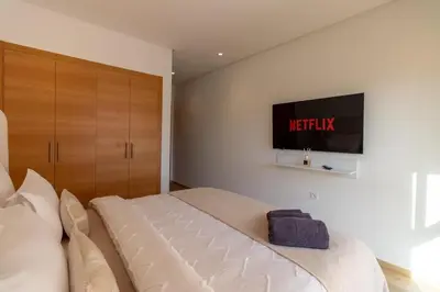 a bedroom with a bed and a tv on the wall at Marrakech prestigia in Marrakech