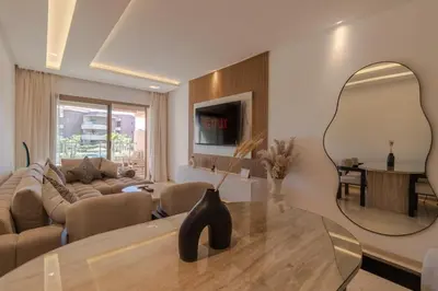 a living room with a table and a large mirror at Marrakech prestigia in Marrakech