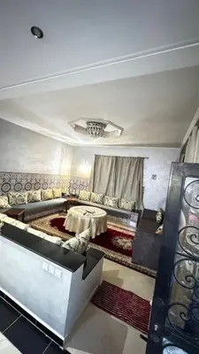a living room with a table and a couch at Villa Elbidaoui in Marrakech