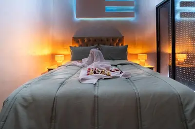 a bedroom with a large bed with a towel on it at Marrakech Calm Getaway 2 Pools & City Access in Marrakech